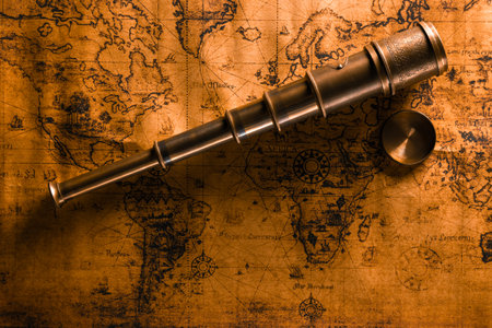 Travel geography background. Old spyglass on geographical vintage atlas map of the world.の写真素材