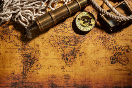 Travel geography background. Old spyglass, rope, vintage compass and magnifying glass on...