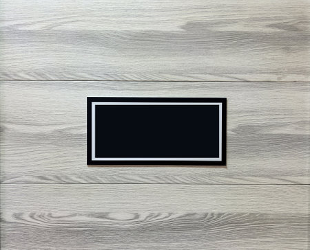 Black empty sign on light gray wooden background.
