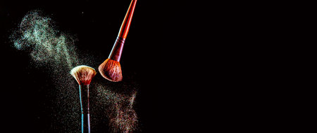 Make up cosmetic brushes with colorful shadows explosion on black background. Skin care or fashion concept. Free space for your text.の写真素材