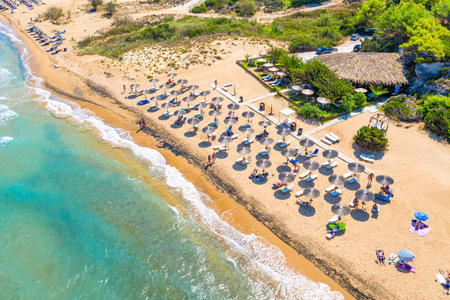Top view aerial drone photo of Banana beach with beautiful turquoise water, sea waves and straw umbrellas. Vacation travel background. Ionian sea, Zakynthos Island, Greece.の写真素材
