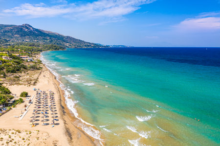 Top view aerial drone photo of Banana beach with beautiful turquoise water, sea waves and straw umbrellas. Vacation travel background. Ionian sea, Zakynthos Island, Greece.の写真素材