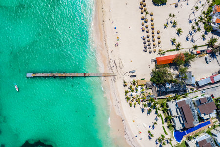 Aerial view of Bavaro beach Punta Cana tropical resort in Dominican Republic. Beautiful atlantic tropical beach with palms, umbrellas and bridge.の写真素材