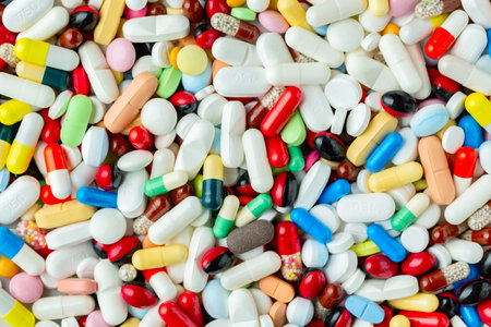Health care and treatment concept. Huge pile of colorful pills, tablets and capsules background.の写真素材