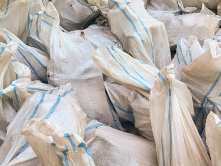 Construction site concept. Bags of cement or construction bags background.