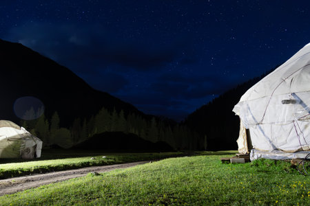 Djeti-Oguz valley Yurt camp night landscape with stars. Tien Shan mountain ridge, located in the southeast of the Issyk-Kul basin, Kyrgyzstan.の写真素材
