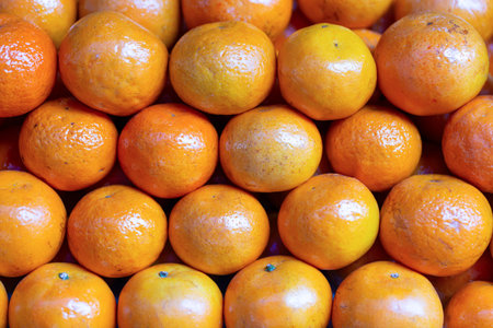 Fresh ripe tangerines or mandarines on display at the market.