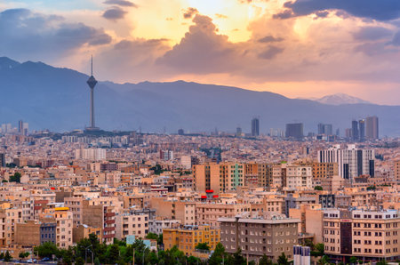 Beautiful cityscape sunset panorama of Tehran city, mountains and Milad tower in during colorful...