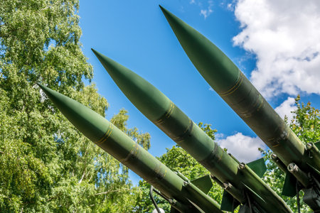 Military intrusion concept. Old anti aircraft guns artillery against trees outdoors.の写真素材