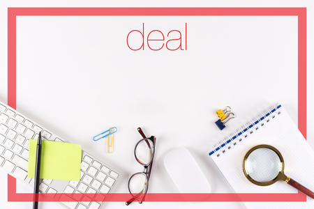 High angle view of various office supplies on desk with a word Dealの写真素材