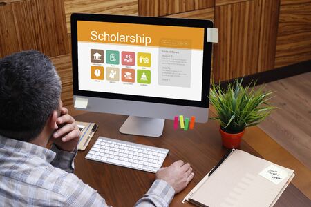 Man using computer with Scholarship concept on screen