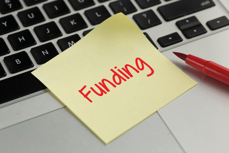 Funding sticky note pasted on the keyboard