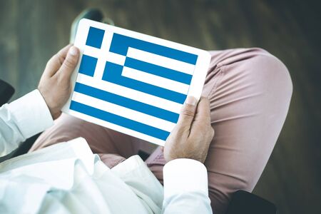 People using tablet pc and showing on the screen the flag of GREECEの写真素材