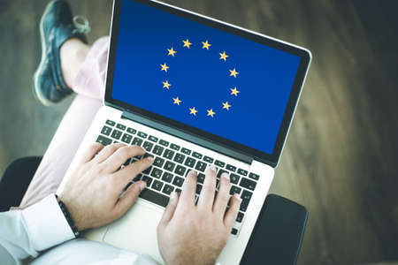 People using laptop and showing on the screen the flag of EUROPEAN UNION