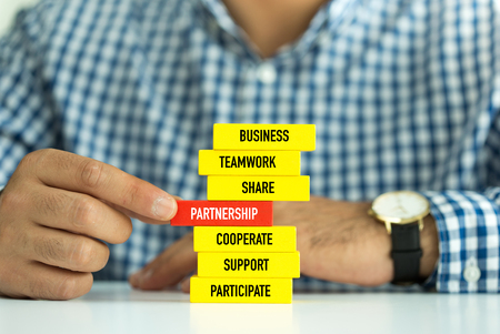 Businessman Building PARTNERSHIP concept with Wooden Blocksの写真素材