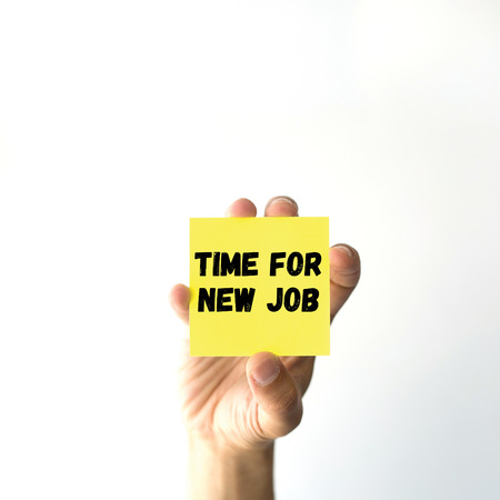 Hand holding yellow sticky note written TIME FOR NEW JOB wordの写真素材