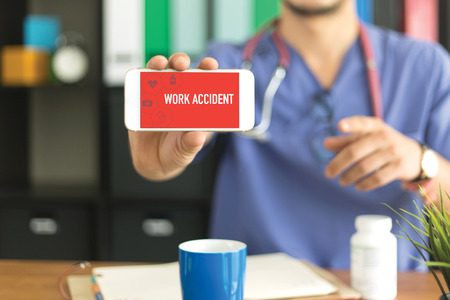 Young and professional medical doctor showing a smartphone and WORK ACCIDENT concept on screen