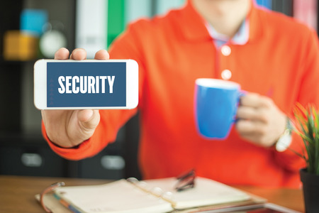 Young man showing smartphone and SECURITY word concept on screenの写真素材