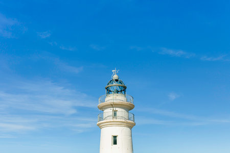 Maritime lighthouse on a blue summer sky.の写真素材