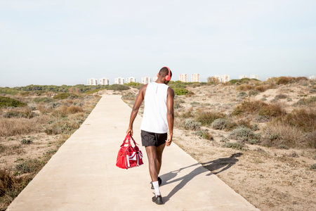 Young black athlete who walks away after training. Concept of sport.