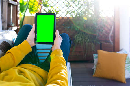 Unrecognizable man with a tablet with green screenの写真素材