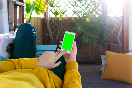 Unrecognizable man with a cellular with green screenの写真素材