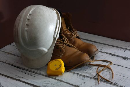 work boots, with white helmet and yellow meterの写真素材