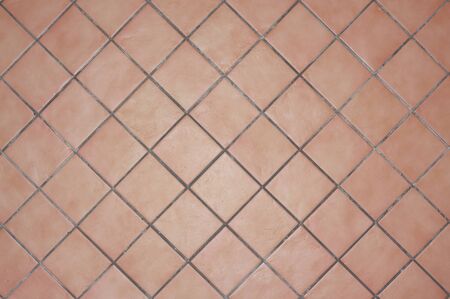 Terracotta tiles, ocher colors, earth tones, placed in carton, with gray cement joint, tiles from...