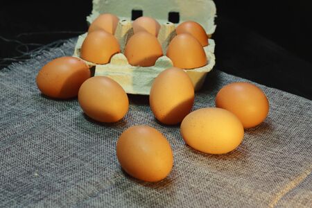 brown chicken eggs, on a cloth to prevent them from moving