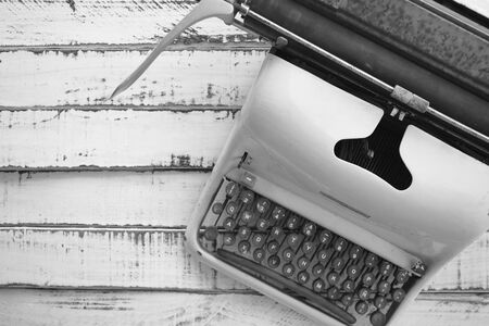 old typewriter painted in pink, on a white tableの写真素材