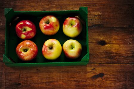 red apples in a green fruit boxの写真素材