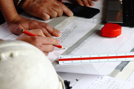 construction workers consulting the construction plansの写真素材