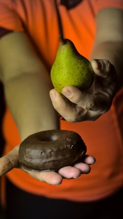 diet concept, overweight by confinement, choosing between fruit or industrial pastries, healthy diet