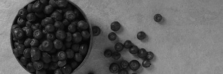 blueberries on a brown wooden bowlの写真素材