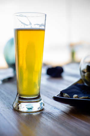 Cloudy beer, photograph against the light on a restaurant table