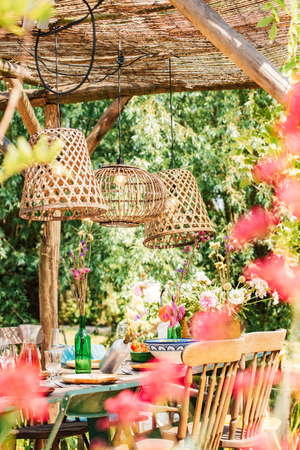 Colourful decorated table in summer setting. Garden party. Lunch. Summer garden