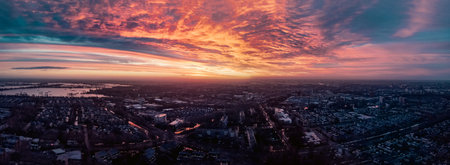 Wide panorama drone shot of an epic red sunrise in the Netherlands.の写真素材