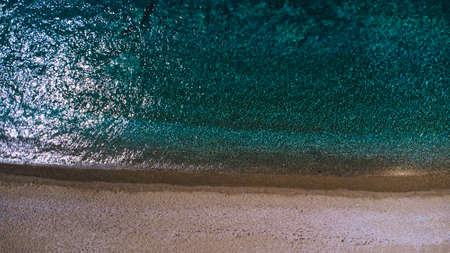 Summer seashore with turquoise water and yellow sand. Drone shot.