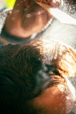 Barbershop close-up. Comb in hair and water spray.の写真素材