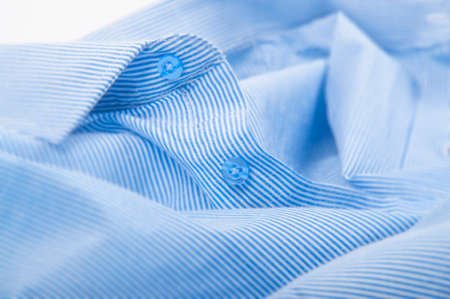 Buttons down shirt macro on whitw backgroundの写真素材