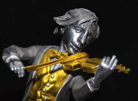 Fiddler statuette  isolated on blackの写真素材