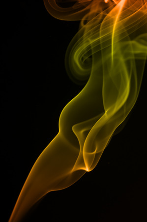 Floating colored smoke waves on solid background の写真素材