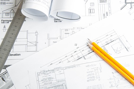 Construction planning drawings on the table and two yellow pencilsの写真素材