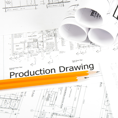 Construction planning drawings on the table and two yellow pencilsの写真素材