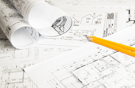 Construction planning drawings on the table and two yellow pencilsの写真素材