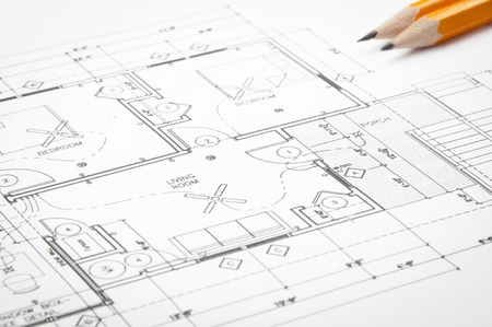 Construction planning drawings on the table and two yellow pencilsの写真素材