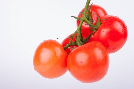 Bunch  of red cherry tomatos isolated on the white backgroundの写真素材