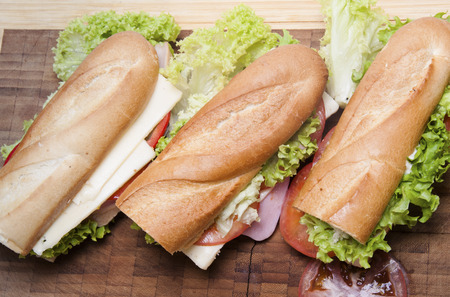 Big fresh baguette sandwich isolated on the white backgroundの写真素材
