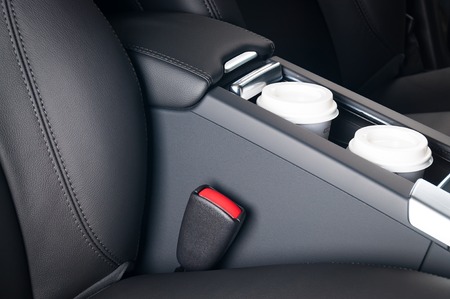 Coffee Drinking While Driving. Paper Coffee Cups Inside Car Cup Holder.