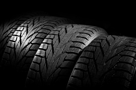 Car tires close-up Winter wheel profile structure on black backgroundの写真素材